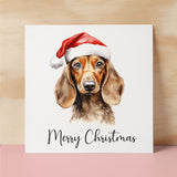 Fun Christmas Card of a Dachshind Dog Wearing A Santa Hat Whimsical Watercolour Christmas Card For Animal Lover For Him or Her