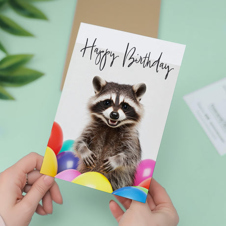 Fun Birthday Card Featuring A Cute Racoon and Colourful Birthday Balloons For Boys Or Girls Him Or Her